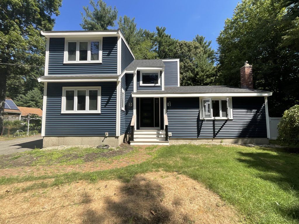 New residential home siding with dark blue CertainTeed Monogram® vinyl siding